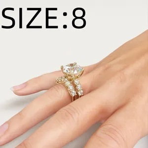 Gold ring set close-up detail showcasing sparkling round zircon stones on delicate bands size 8.