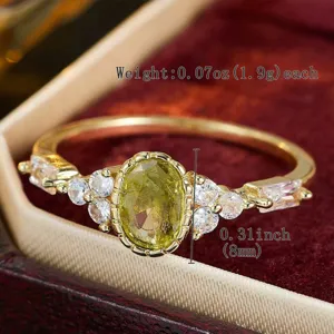 Detailed shot of retro olive green zirconia ring with clear cubic zirconia gold band.
