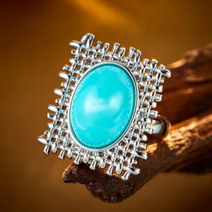 Vintage silberfarbener Ring mit künstlichem Türkis und feinem filigranem Hohlmuster.