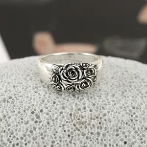 Vintage Thai silver wide ring featuring detailed 3D embossed multi-rose floral cluster design.