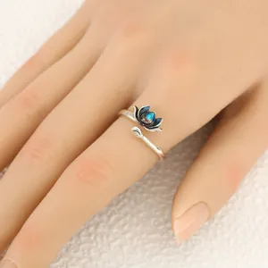 Detailed shot of a vintage blue and black gradient lotus adjustable open ring jewelry piece.