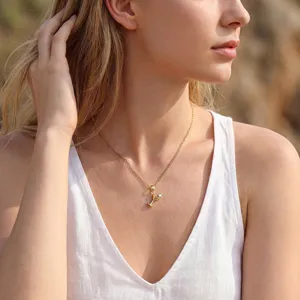 Delicate gold-plated cocktail glass pendant necklace showcasing sparkling cubic zirconia detail.
