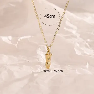 Golden bullet pendant necklace with chain detail, minimalist jewelry close-up view