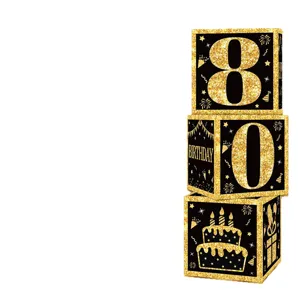 Detailed view of black and gold birthday decorative boxes showing number 80 and cake graphic.