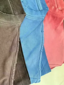 Close-up detail of heavy distressed vintage washed short sleeve t-shirts showing seams.
