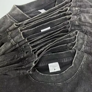 Close-up detail of vintage washed short sleeve t-shirt collar and textured cotton fabric.