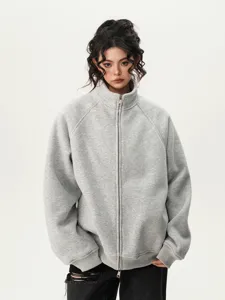Grey zip-up hoodie detail showcasing high collar, metal zipper, and heavy fabric.