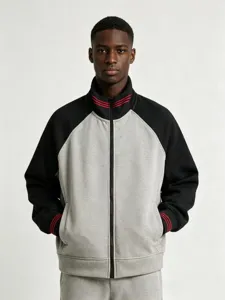 Detail view of a vintage colorblock zip-up stand collar sweatshirt with striped cuffs.