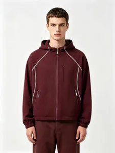 Detail shot of the maroon waffle knit zip-up hoodie jacket with contrast white stitching.