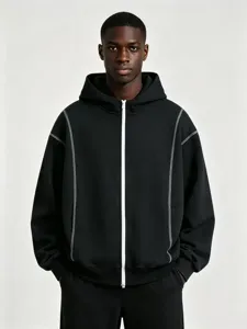 Discover our stylish black zipped hoodie featuring striking white contrast stitching details.