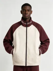 Close-up view of the two-tone zip-up jacket featuring contrast sleeves and striped collar.