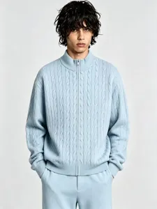 Men's light blue stand collar full zip cable knit sweater detail showing texture and cuffs.