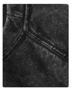 Detailed view of the collar and shoulder seam on a vintage distressed acid wash t-shirt.