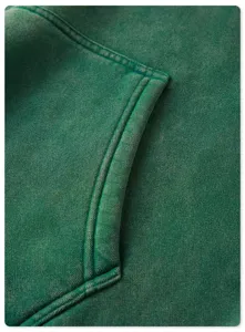 Close-up detail of a vintage washed green heavy hoodie pocket and premium textured fabric.