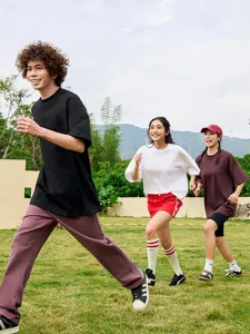 Outdoor casual lifestyle detail view of solid color short sleeve t-shirts worn by active models.