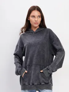 Close-up detail of the vintage washed oversized hoodie showing heavy fleece texture and pocket.