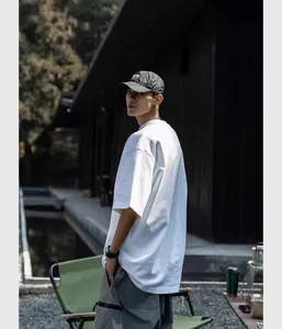 Detail shot of heavy pure cotton dropped shoulder oversized t-shirt in solid white color.