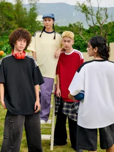 Outdoor group shot detail of heavy cotton loose drop-shoulder color-block short tees.