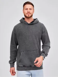 Close-up of the vintage washed dark grey hoodie showing premium fabric texture and pocket.