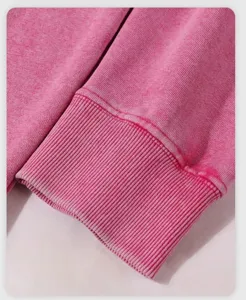 Pink washed hooded sweatshirt sleeve detail, showing soft loopback fabric and rib knit cuff.