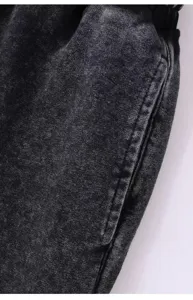 Heavy washed fleece hoodie detail close-up showing vintage acid wash texture and precise stitching.