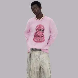 Detail view of men's pink long sleeve graphic sweatshirt with loose fit and artistic print.