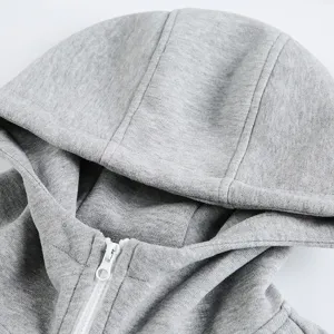 Grey zip-up hoodie detail view, showing soft fabric texture, double zipper, and adjustable hood.