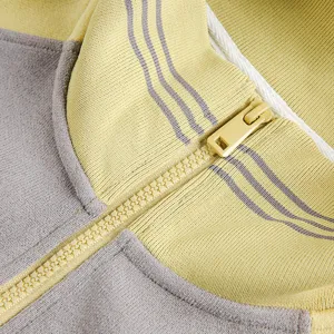 Detail view of the zipper collar and color-blocked fabric texture for the stylish sweatshirt.