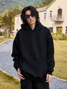 Heavy fleece-lined black hooded sweatshirt detail, warm casual streetwear style for men.