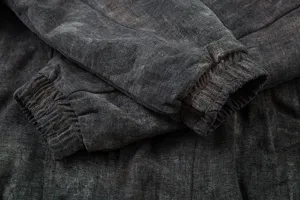 Winter thickened cotton coat detail featuring warm dark grey washed fabric and ribbed cuffs.