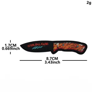 Detailed view of the embroidered knife patch featuring Into the Wild text and exact dimensions.