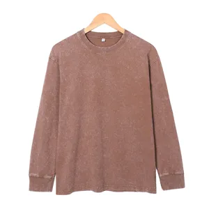 Vintage washed brown long sleeve crewneck t-shirt detail, showing ribbed collar and fabric.