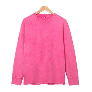 Close-up of the vintage washed pink long sleeve t-shirt, showing soft fabric texture and crew neck.