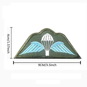 Close-up detail of the embroidered parachute wings badge with clear dimension markers.