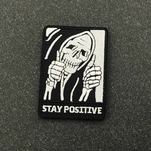 Close-up of the black and white embroidered skeleton morale patch with detailed stitching.
