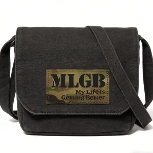 Detailed view of black canvas messenger bag with tactical camouflage patch and bold text.