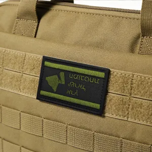 Close-up detail of tactical bag surface showing MOLLE webbing and custom embroidery patch.