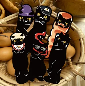 Close-up detail of cute black cat bookmarks featuring quirky humorous designs in basket.