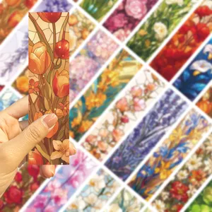 Close-up of a vintage stained glass style floral bookmark held in hand showing art details.