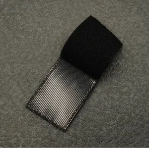 Black reflective velcro patch detail showing tactical morale badge texture and finish