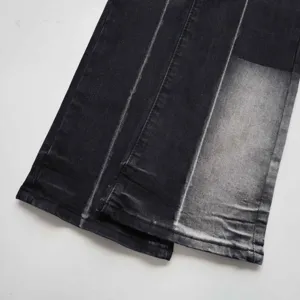 Dettaglio di jeans svasati neri vintage con trama slavata bianca unica e moderna