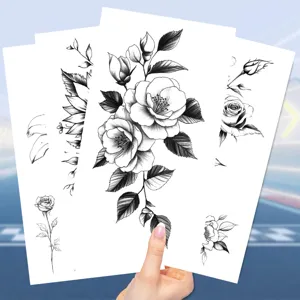 Detailed close-up view of black sketch floral temporary tattoo sheets for body art.