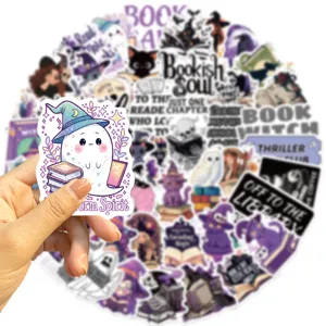 Close-up detail shot of a cute bookish ghost sticker featuring a witch hat and book designs.