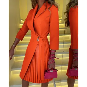 Close-up of vibrant orange V-neck pleated wrap dress featuring waist tie and metal buckle