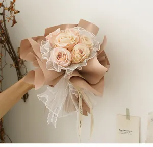 Korean style rose bouquet with brown wrapping paper and white pleated lace mesh detail.