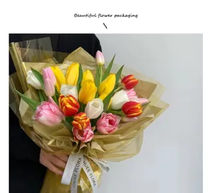 Detailed view of a colorful tulip bouquet wrapped in waterproof clear cellophane with ribbon.