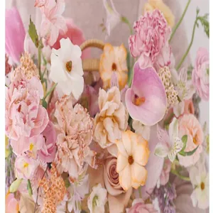 Fresh floral arrangement detail showcasing mixed pastel pink and peach roses for decoration.