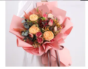 Beautiful pink artificial flower bouquet detail shot with wrapping paper, romantic floral.
