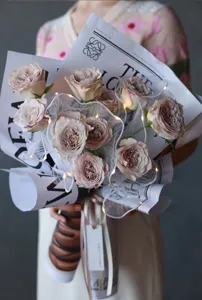Korean style floral wrapping mesh with LED lights for elegant bouquet and cake packaging.