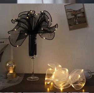 Detailed view of Korean style glowing wavy mesh ribbon with LED lights for creative packaging.